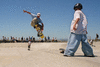 PhotographA skateboarder performing an aerial trick at a California skate park.